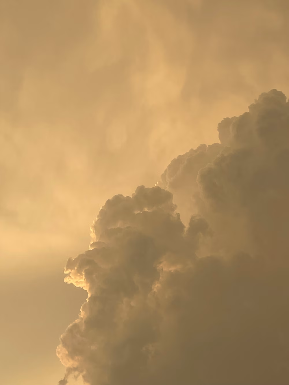 Golden Sunset Clouds Over Dramatic Sky With Towering Cumulus Formation and Warm Light