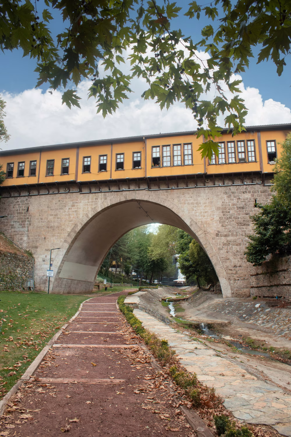 Historic Ottoman Bridge Framed by Autumn Leaves