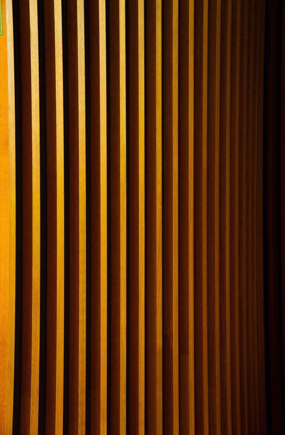 Warm Wooden Vertical Slats Patterned Wall Paneling With Repeating Lines And Modern Interior Texture