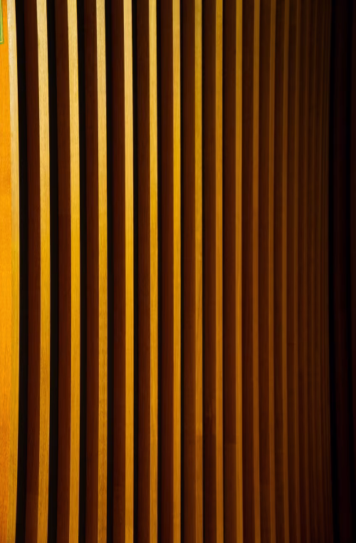 Warm Wooden Vertical Slats Patterned Wall Paneling With Repeating Lines And Modern Interior Texture